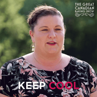 A Woman In A Floral Shirt Stands In Front Of A Sign That Says " Keep Cool " GIF