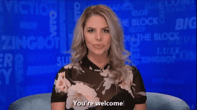 A Woman In A Floral Top Is Sitting In Front Of A Blue Background And Says You 'Re Welcome GIF