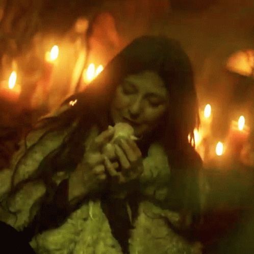 Woman In Fur Coat Holding Candle GIF