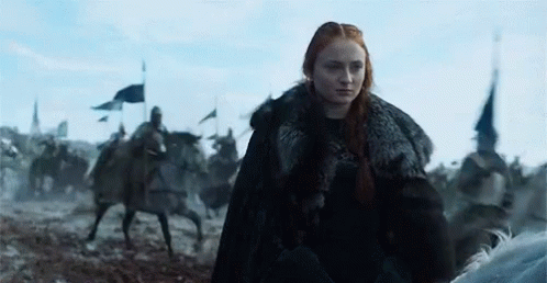 A Woman In A Fur Coat Is Riding A Horse In A Field With Soldiers On Horses . GIF
