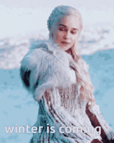 A Woman In A Fur Coat Is Standing In The Snow And Says Winter Is Coming GIF