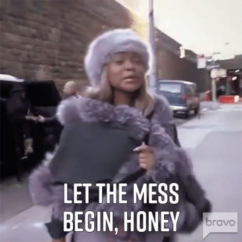 A Woman In A Fur Coat Is Walking Down A Street And Says Let The Mess Begin Honey . GIF