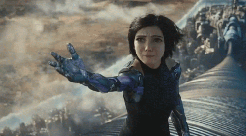 A Woman In A Futuristic Suit Reaches Out Her Hand GIF