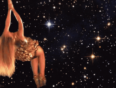 A Woman In A Gold Dress Is Dancing In The Stars GIF