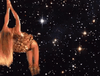 A Woman In A Gold Dress Is Flying Through The Air Surrounded By Stars GIF