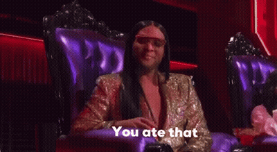 A Woman In A Gold Jacket Is Sitting In A Purple Chair And Talking . GIF