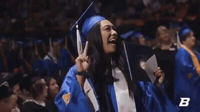 A Woman In A Graduation Cap And Gown Is Holding A Diploma With The Letter B In The Corner GIF