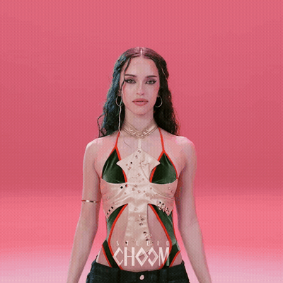 A Woman In A Green And White Top With The Word Choom On Her Chest GIF