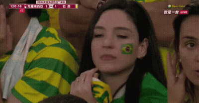 A Woman In A Green And Yellow Striped Shirt Has A Green Circle Painted On Her Face GIF