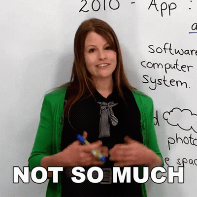 A Woman In A Green Cardigan Stands In Front Of A White Board That Says 2010 App Software Computer System GIF
