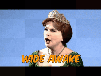 A Woman In A Green Dress And A Tiara Says Wide Awake GIF