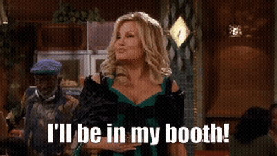 A Woman In A Green Dress Is Saying I 'Ll Be In My Booth . GIF