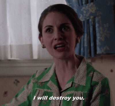 A Woman In A Green Dress Is Talking And Says I Will Destroy You . GIF