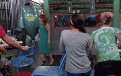 A Woman In A Green Dress Stands In Front Of A Green Robot That Says Zugrut GIF