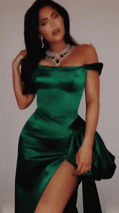 A Woman In A Green Dress With A Necklace On GIF