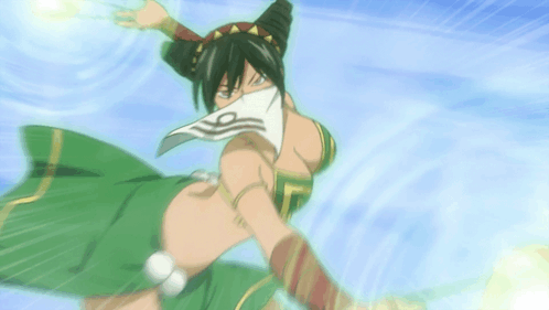 A Woman In A Green Dress With A White Scarf Around Her Face GIF