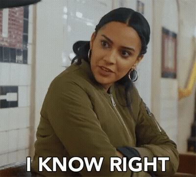 A Woman In A Green Jacket Is Sitting At A Table With Her Arms Crossed And Says `` I Know Right '' . GIF