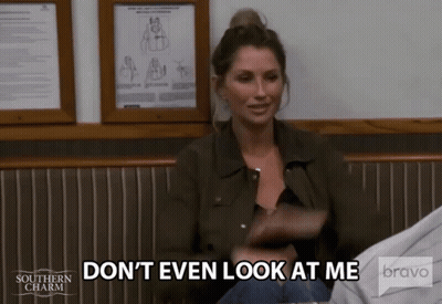 A Woman In A Green Jacket Is Sitting In A Chair And Says " Don 'T Even Look At Me " . GIF