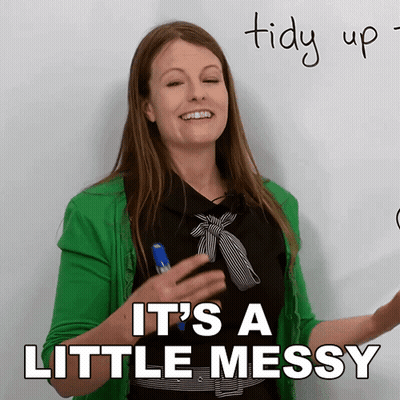 A Woman In A Green Jacket Says It 'S A Little Messy In Front Of A Whiteboard GIF