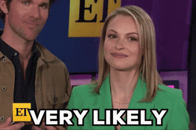 A Woman In A Green Jacket Says Very Likely Next To A Man GIF