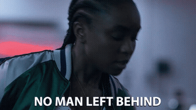 A Woman In A Green Jacket With The Words No Man Left Behind GIF