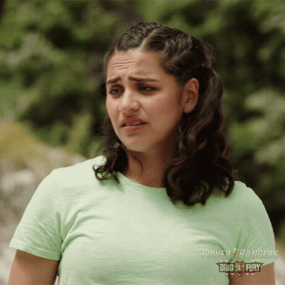 A Woman In A Green Power Rangers T-Shirt GIF