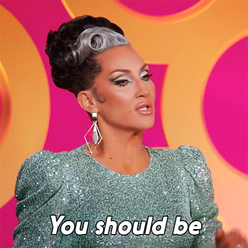 A Woman In A Green Sequined Dress Is Saying You Should Be GIF