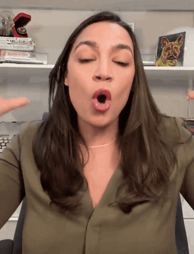A Woman In A Green Shirt Is Making A Face With Her Mouth Open GIF