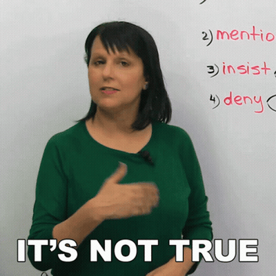 A Woman In A Green Shirt Says It 'S Not True In Front Of A Whiteboard GIF