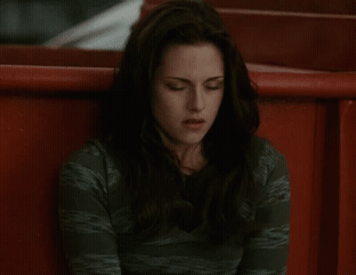 A Woman In A Green Shirt Sits In A Red Chair GIF