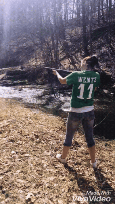 A Woman In A Green Shirt With The Number 11 On It Is Fishing GIF