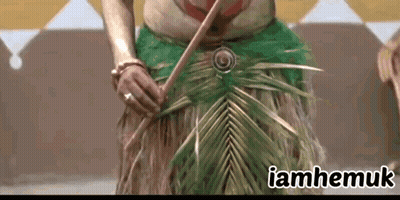 A Woman In A Green Skirt Is Holding A Palm Leaf And The Words Iamhemuk Are Above Her GIF