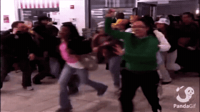 A Woman In A Green Sweater Is Dancing In A Crowd With A Panda Gif Watermark GIF