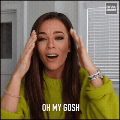 A Woman In A Green Sweater Is Making A Funny Face And Says Oh My Gosh GIF