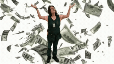 A Woman In A Green Vest Is Standing In Front Of A Pile Of Money That Is Falling From The Sky GIF
