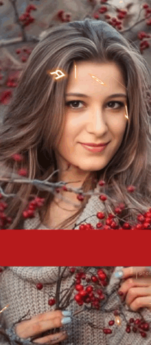 A Woman In A Grey Sweater Is Holding A Branch With Red Berries GIF