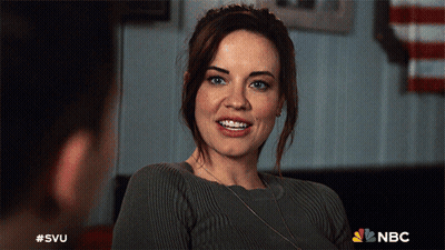 A Woman In A Grey Sweater Is Smiling In A Nbc Advertisement GIF
