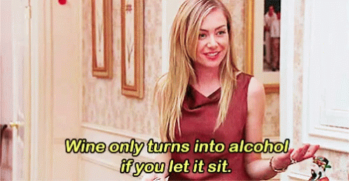 A Woman In A Hallway With The Words Wine Only Turns Into Alcohol If You Let It Sit GIF