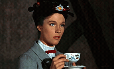 A Woman In A Hat Is Drinking From A Teacup GIF