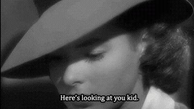 A Woman In A Hat Says Here 'S Looking At You Kid . GIF