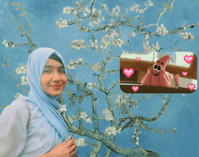 A Woman In A Hijab Is Standing In Front Of A Tree With Flowers GIF
