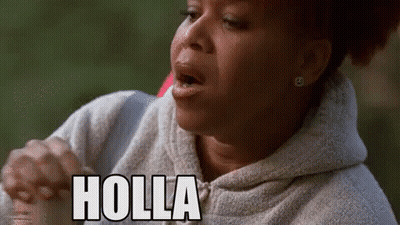 A Woman In A Hoodie Is Making A Funny Face And The Word Holla Is On Her Face . GIF