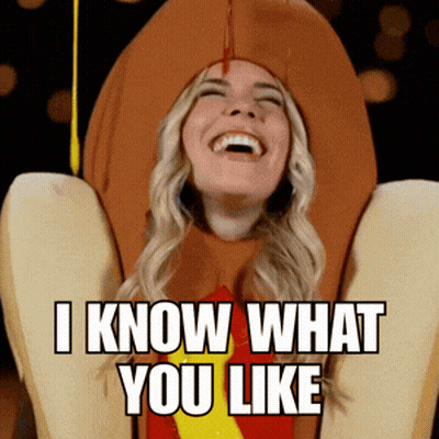 A Woman In A Hot Dog Costume Laughs And Says I Know What You Like GIF