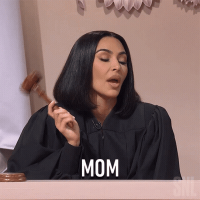 A Woman In A Judge 'S Robe Is Holding A Gavel And The Word Mom Is On The Screen GIF