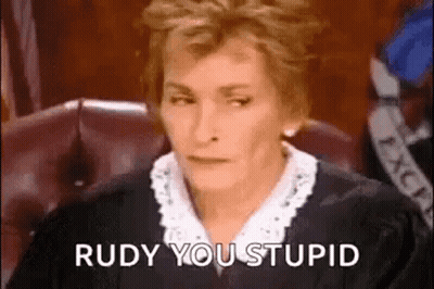 A Woman In A Judge 'S Robe Is Sitting In A Courtroom . GIF
