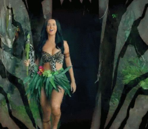 A Woman In A Jungle Outfit Is Walking Through A Zebra Print Tunnel GIF
