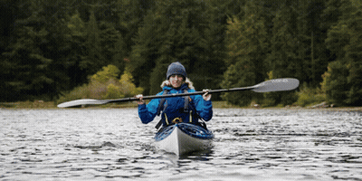 A Woman In A Kayak With A Paddle That Says Winner GIF