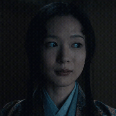 A Woman In A Kimono Is Looking At The Camera GIF