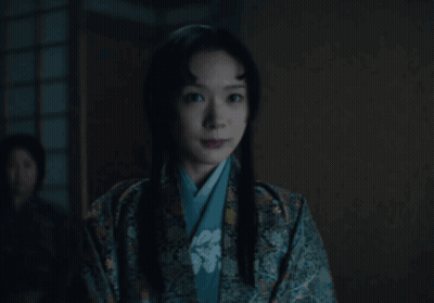A Woman In A Kimono Looks At The Camera GIF