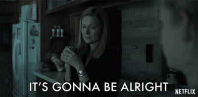 A Woman In A Kitchen Holding A Cup With The Words It 'S Gonna Be Alright On The Bottom GIF